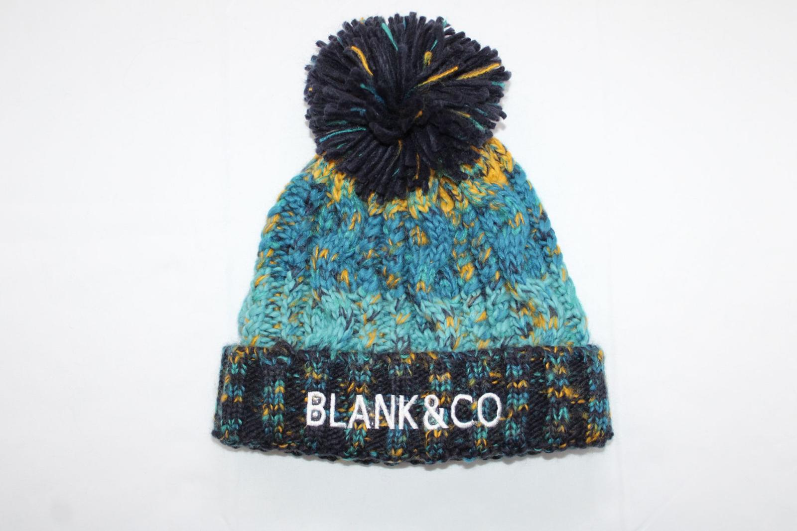 Corkscrew pom pom beanie