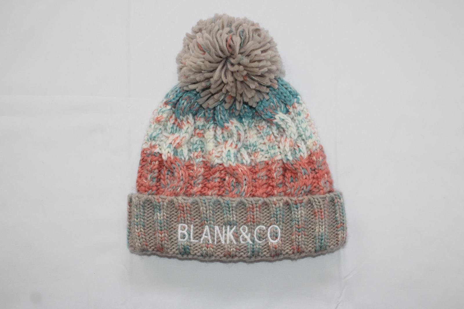 Corkscrew pom pom beanie